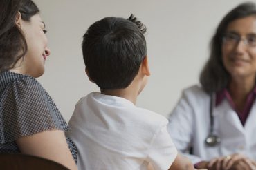Mixed Race doctor talking with patients