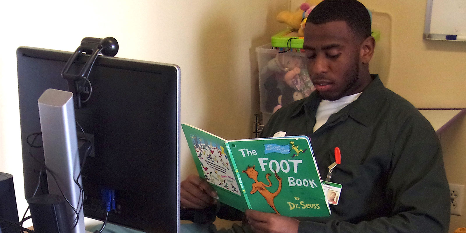 Mr. Johnson reading Dr. Seuss to his kids via video