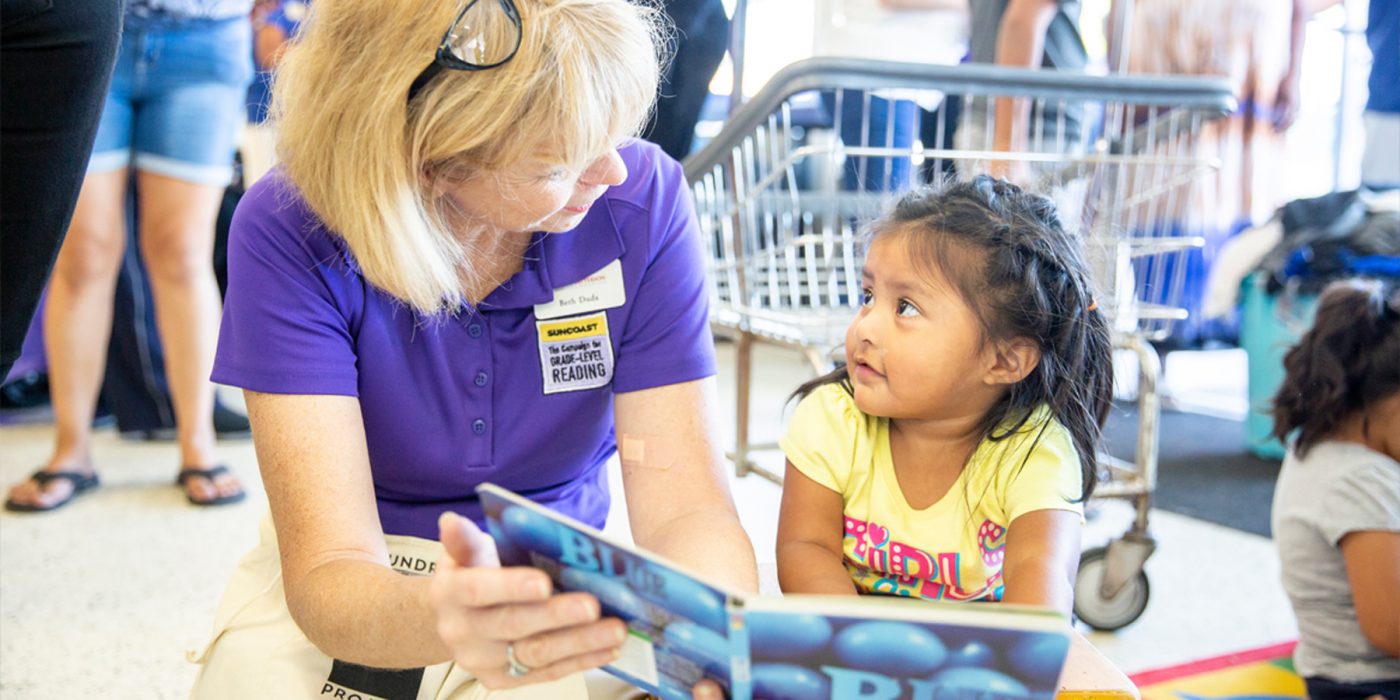 Beth Duda reads to an adorable toddler in a laundromat