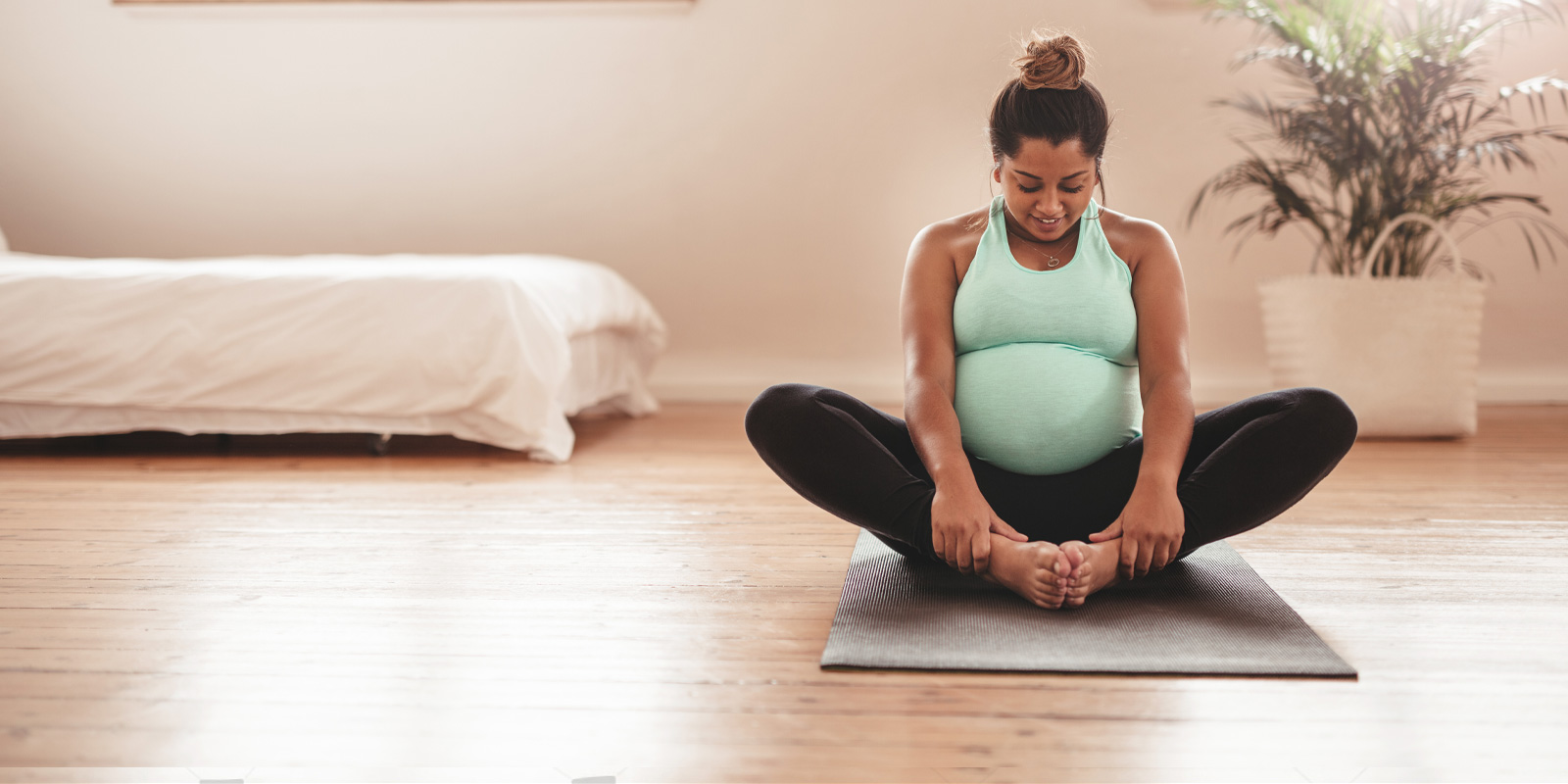 https://earlylearningnation.com/wp-content/uploads/2020/07/smiling-pregnant-person-doing-yoga.jpg