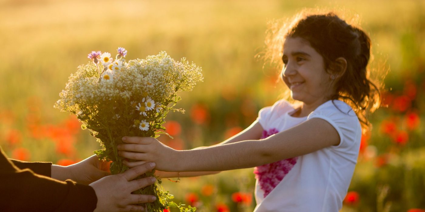 child sharing flowers getty canva Early Learning Nation